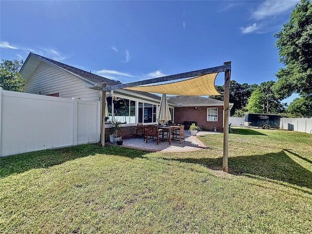 rear view of house featuring a patio and a yard