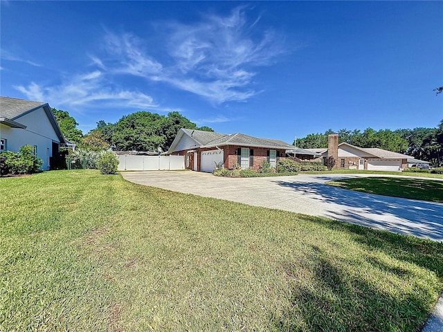 ranch-style home with a front lawn and a garage