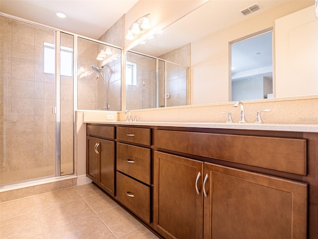 bathroom featuring vanity, an enclosed shower, and tile patterned flooring