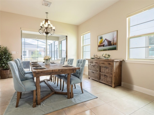 tiled dining room with a notable chandelier