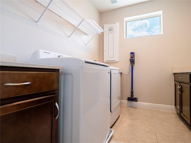 washroom with cabinets, light tile patterned floors, and independent washer and dryer