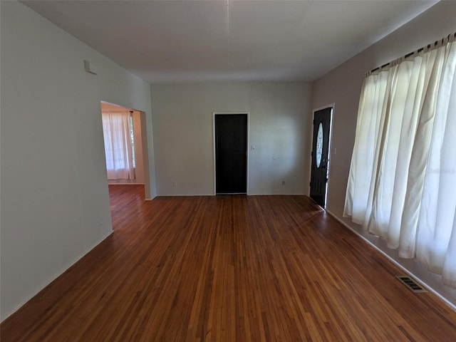 unfurnished room with dark hardwood / wood-style flooring