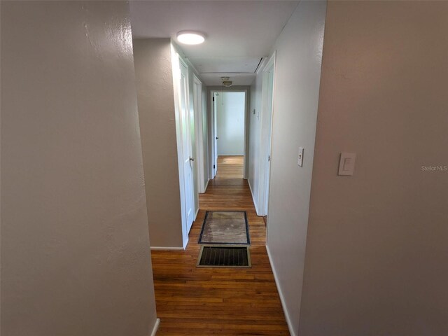 hall with dark hardwood / wood-style flooring