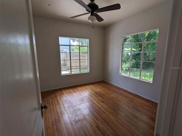 empty room with hardwood / wood-style flooring and ceiling fan