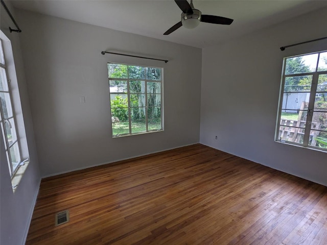 empty room featuring ceiling fan and dark hardwood / wood-style flooring