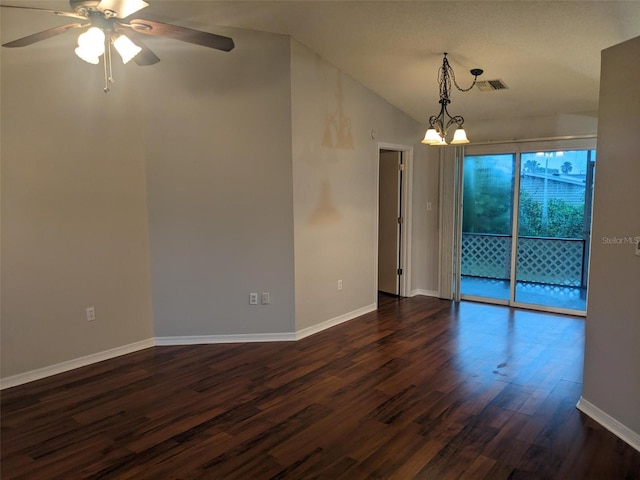 spare room with lofted ceiling, ceiling fan with notable chandelier, and dark hardwood / wood-style floors