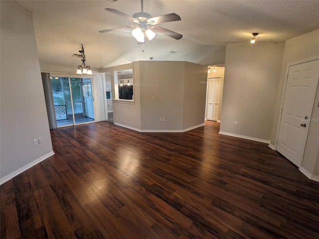 unfurnished living room featuring lofted ceiling, ceiling fan with notable chandelier, a textured ceiling, and dark hardwood / wood-style flooring