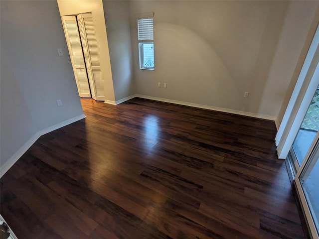 empty room with dark hardwood / wood-style floors