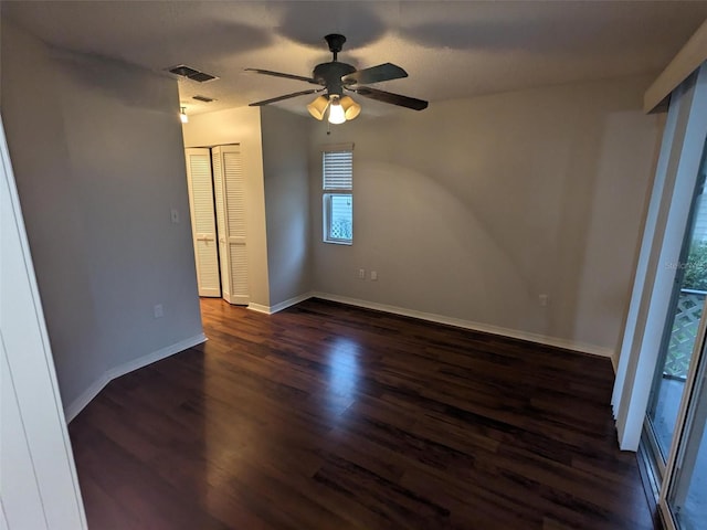 unfurnished room featuring dark hardwood / wood-style floors and ceiling fan