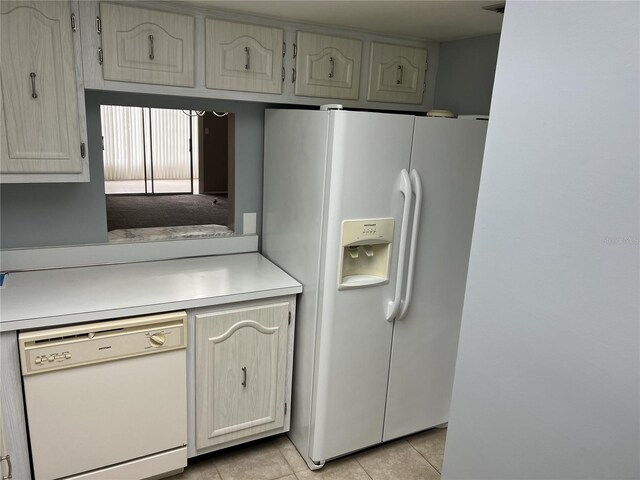 kitchen with white appliances and light tile patterned floors