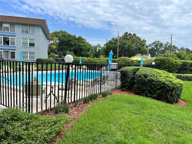 view of swimming pool featuring a lawn