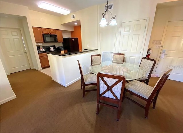 carpeted dining area with an inviting chandelier