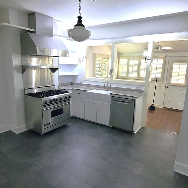 kitchen with stainless steel appliances, ventilation hood, a sink, and light countertops