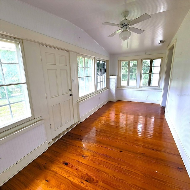 entrance foyer with vaulted ceiling, wood-type flooring, visible vents, and plenty of natural light