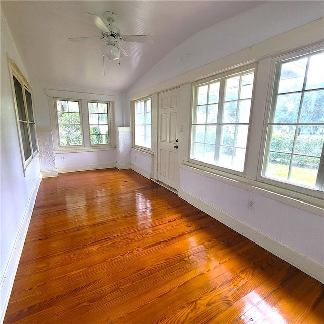 unfurnished sunroom featuring vaulted ceiling and a ceiling fan