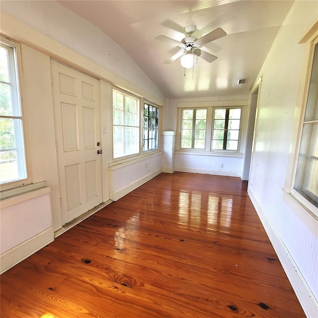 interior space featuring baseboards, vaulted ceiling, and hardwood / wood-style floors