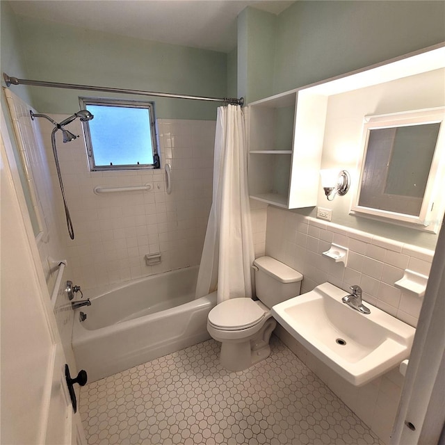 bathroom with toilet, a sink, shower / bath combination with curtain, and tile walls