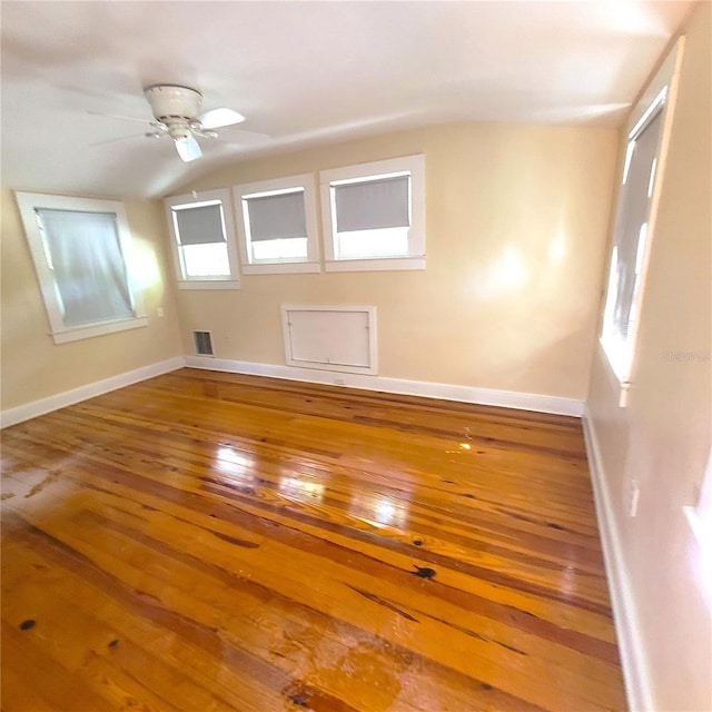 bonus room with lofted ceiling, ceiling fan, visible vents, baseboards, and wood-type flooring