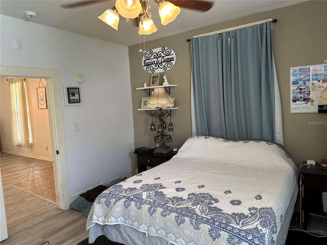 bedroom featuring ceiling fan and hardwood / wood-style floors