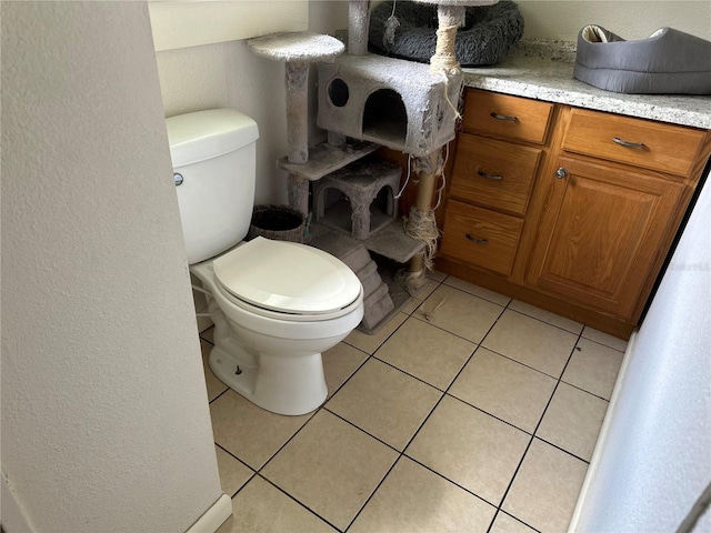 bathroom featuring toilet, tile patterned flooring, and vanity