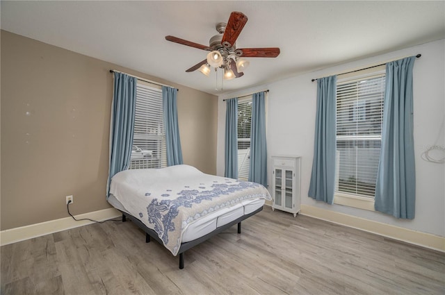 bedroom with ceiling fan and light hardwood / wood-style floors