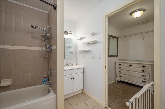 bathroom with vanity, tile patterned floors, and tiled shower / bath