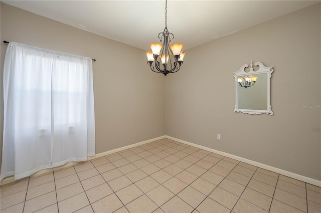 tiled empty room featuring a notable chandelier