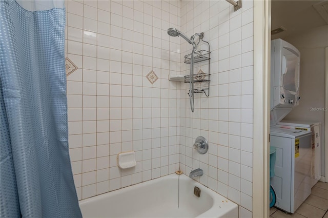 bathroom with tile patterned flooring, stacked washer / drying machine, and shower / bath combo with shower curtain