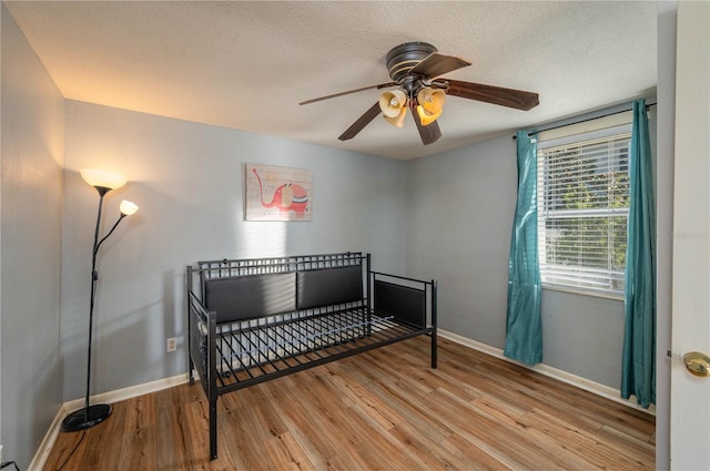 bedroom with ceiling fan and light wood-type flooring