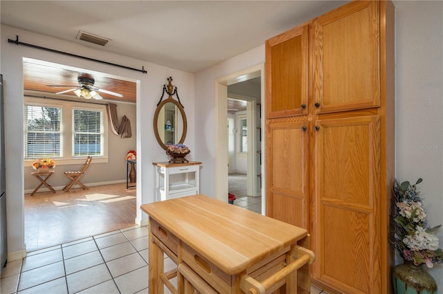 tiled dining room with ceiling fan