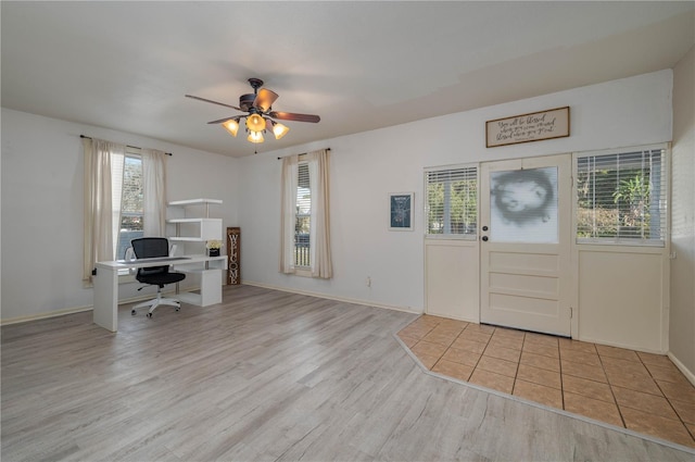 foyer entrance with ceiling fan and light hardwood / wood-style floors