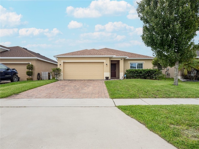 ranch-style home with a front yard and a garage