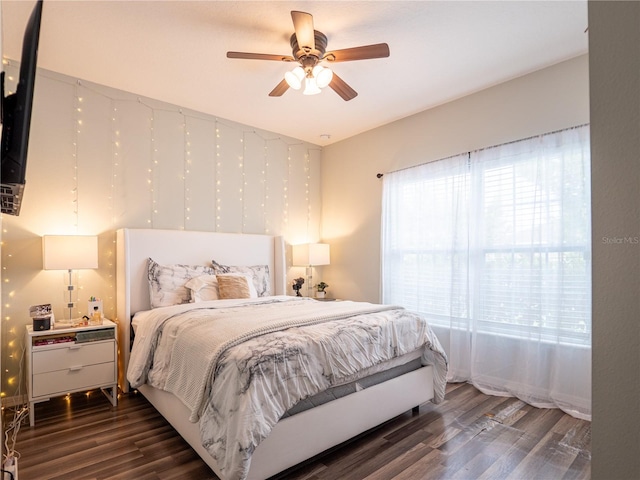 bedroom featuring ceiling fan and dark wood-type flooring