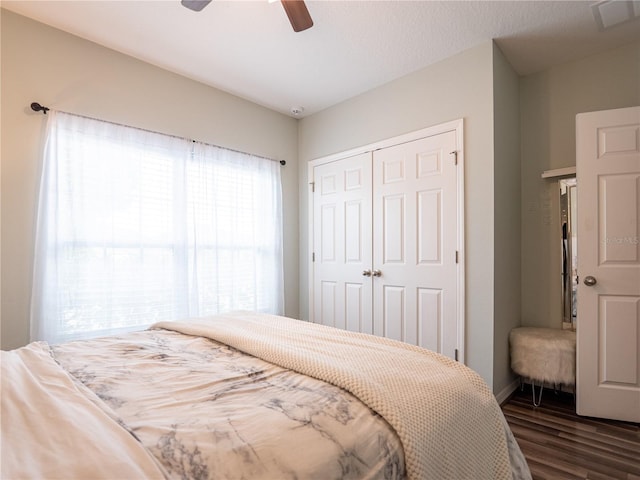 bedroom featuring a closet, ceiling fan, and dark hardwood / wood-style flooring