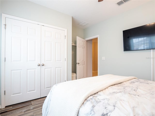 bedroom with ceiling fan, hardwood / wood-style flooring, and a closet