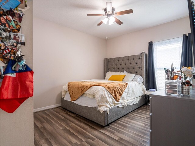 bedroom with ceiling fan and dark wood-type flooring