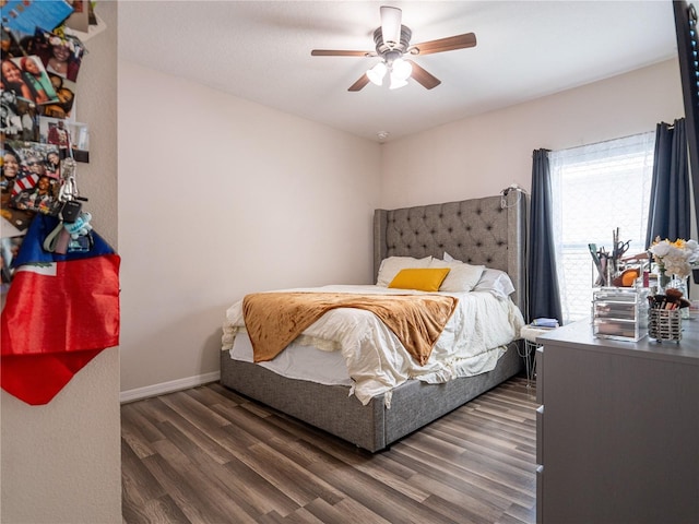 bedroom with dark hardwood / wood-style flooring and ceiling fan