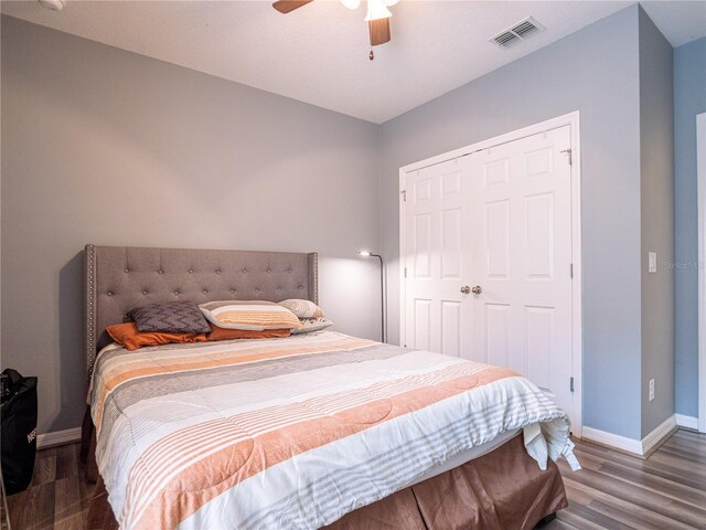 bedroom featuring hardwood / wood-style flooring, a closet, and ceiling fan