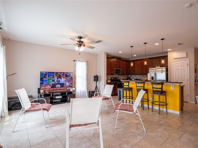 living room with ceiling fan and light tile patterned floors