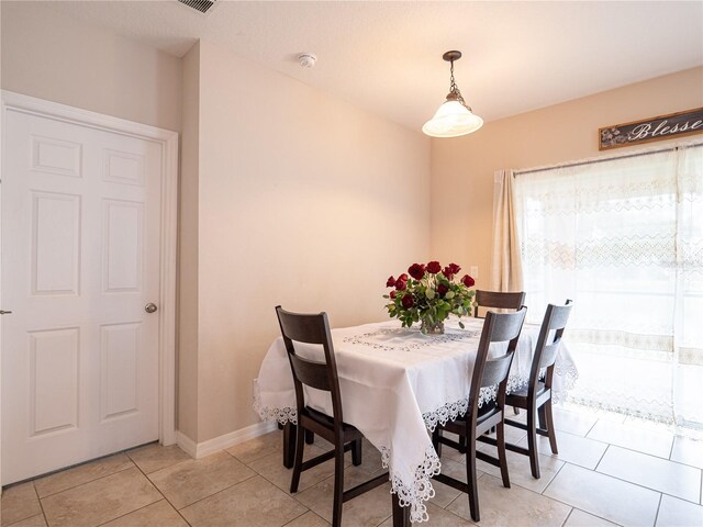 dining area featuring light tile patterned floors