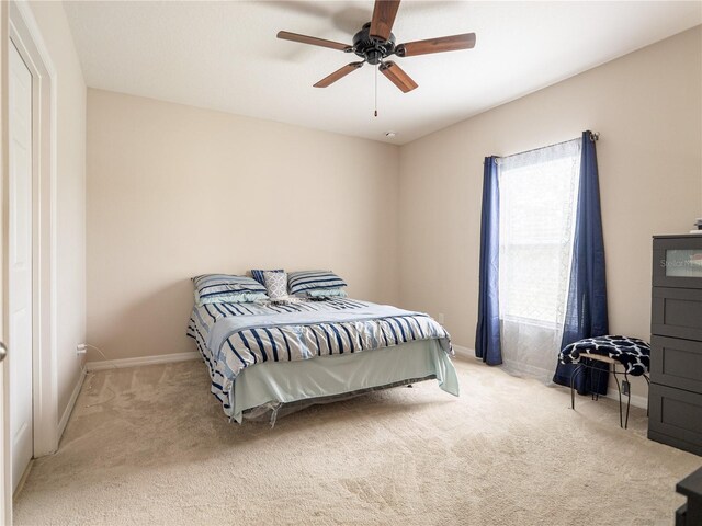 carpeted bedroom featuring ceiling fan