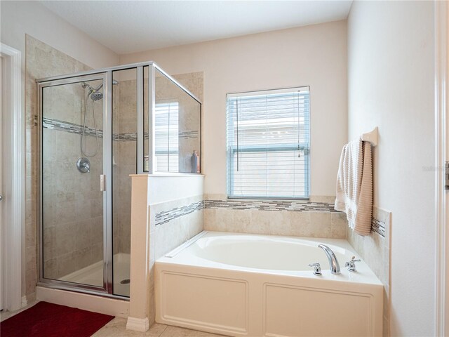 bathroom featuring tile patterned flooring and separate shower and tub