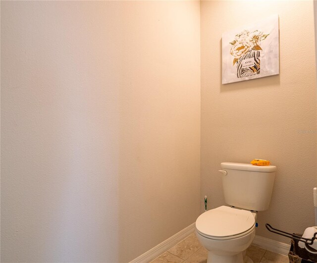 bathroom featuring tile patterned flooring and toilet