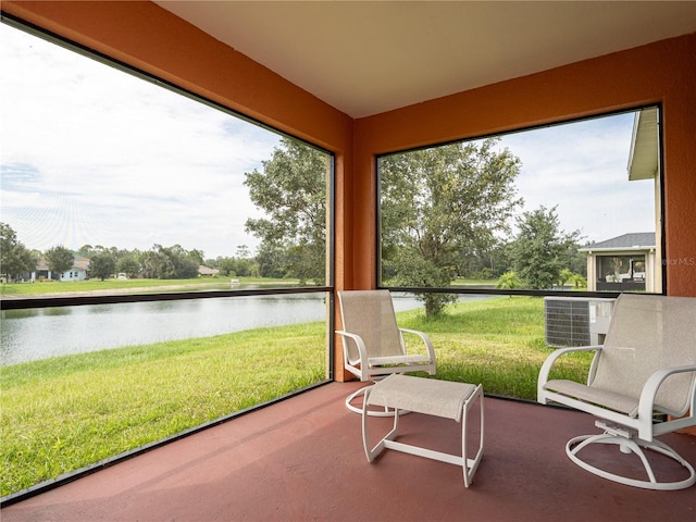 sunroom / solarium with a water view