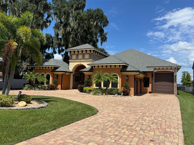 view of front of home featuring a garage and a front lawn