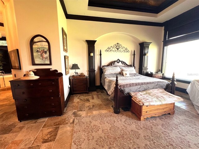 tiled bedroom with ornate columns, a raised ceiling, and a high ceiling