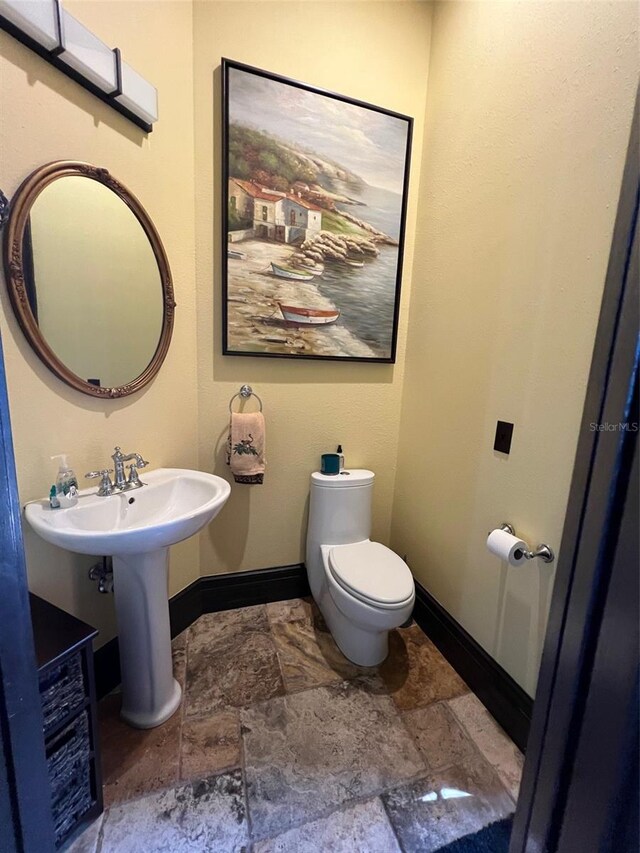 bathroom with tile patterned flooring and toilet