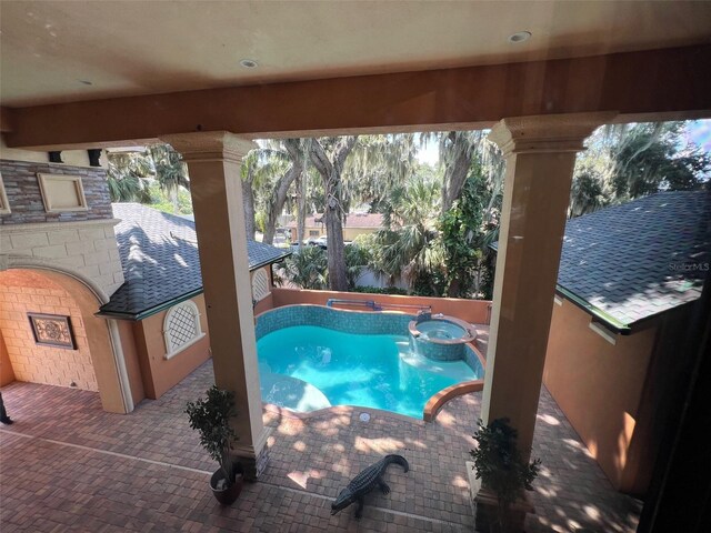 view of swimming pool with an in ground hot tub and a patio