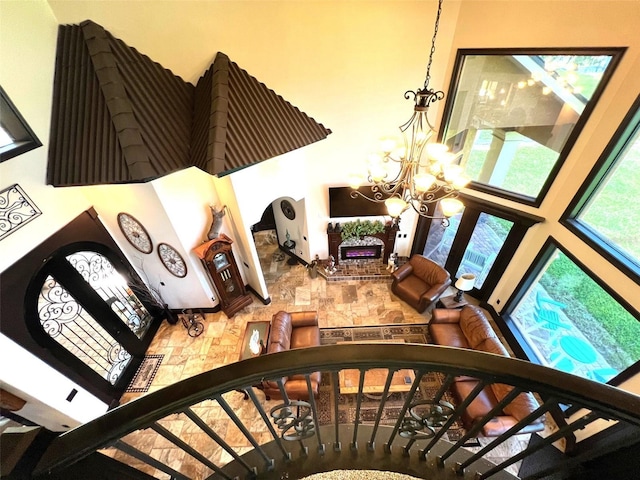 stairs featuring a towering ceiling and an inviting chandelier