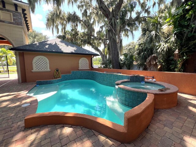 view of pool featuring a patio area and an in ground hot tub